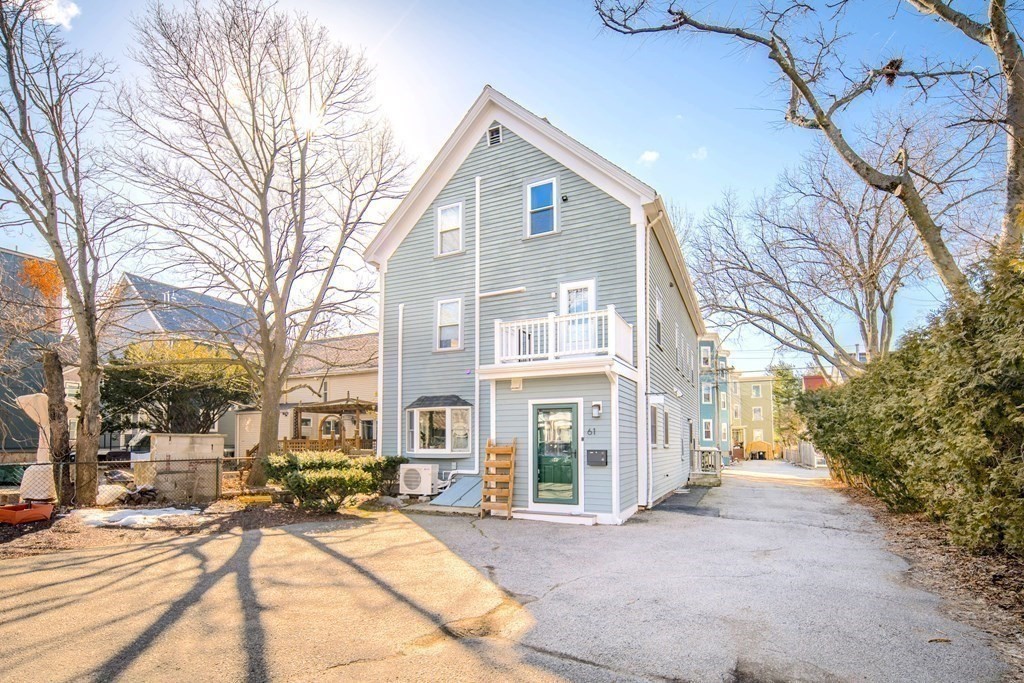 63 Reed Street, Unit 63 Cambridge, MA 02140 - Photo 15 of 16 a front view of a building with large trees