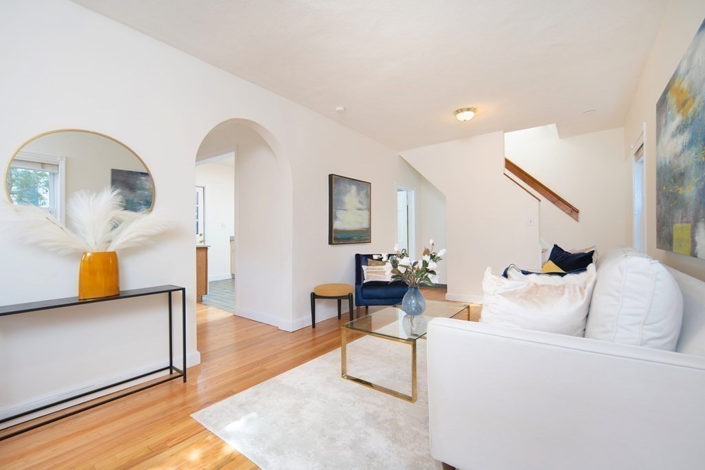63 Reed Street, Unit 63 Cambridge, MA 02140 - Photo 2 of 16 a living room with furniture and wooden floor