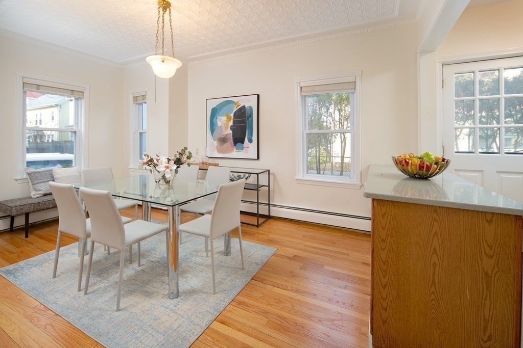 63 Reed Street, Unit 63 Cambridge, MA 02140 - Photo 4 of 16 a dining room with chandelier and wooden floor