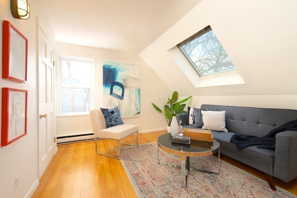 63 Reed Street, Unit 63 Cambridge, MA 02140 - Photo 5 of 16 a living room with furniture and a table