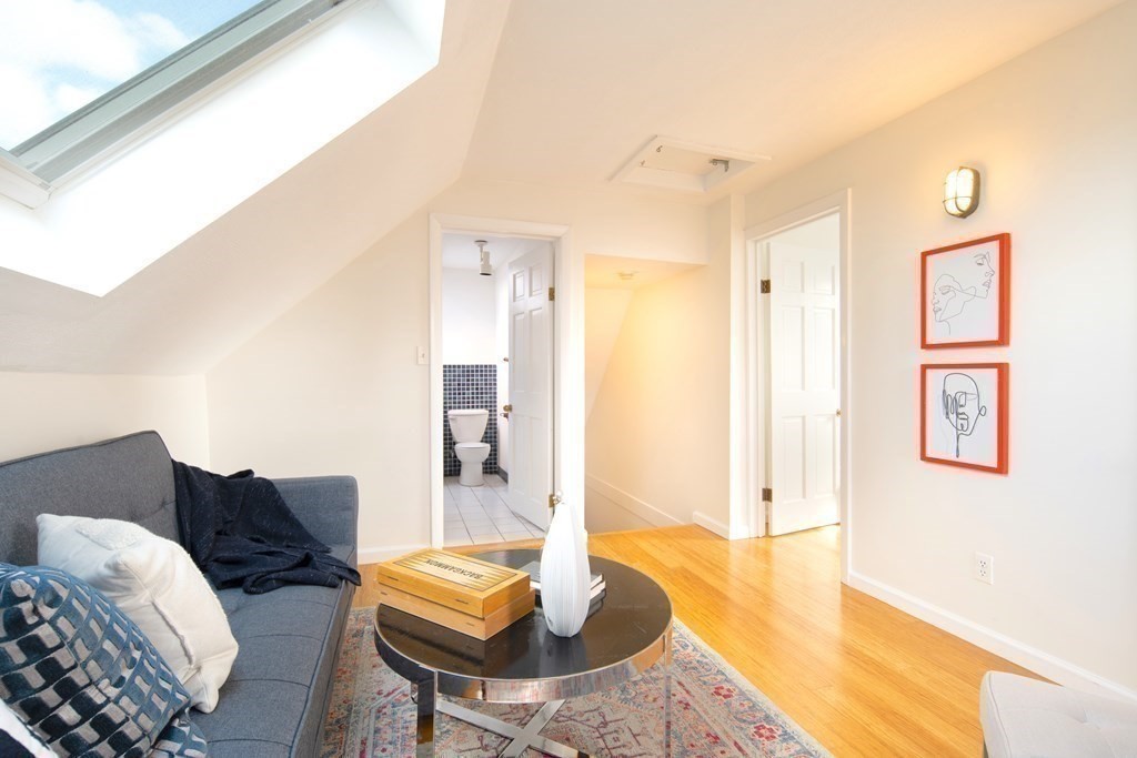 63 Reed Street, Unit 63 Cambridge, MA 02140 - Photo 6 of 16 a living room with furniture and a wooden floor