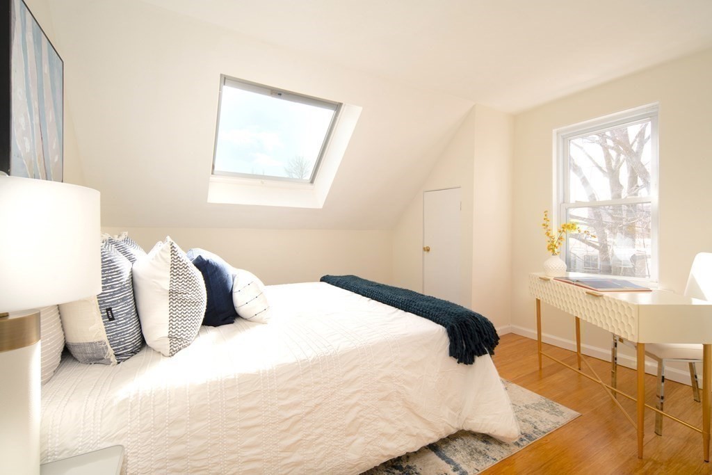 63 Reed Street, Unit 63 Cambridge, MA 02140 - Photo 7 of 16 a bedroom with a bed and a window