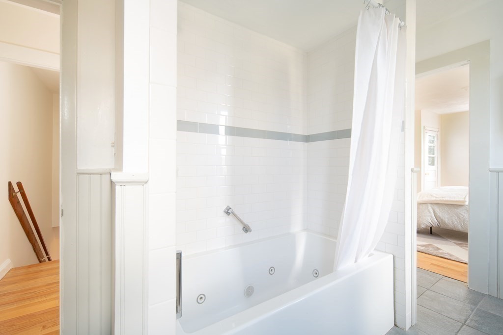 63 Reed Street, Unit 63 Cambridge, MA 02140 - Photo 8 of 16 a bathroom with a bathtub and a shower