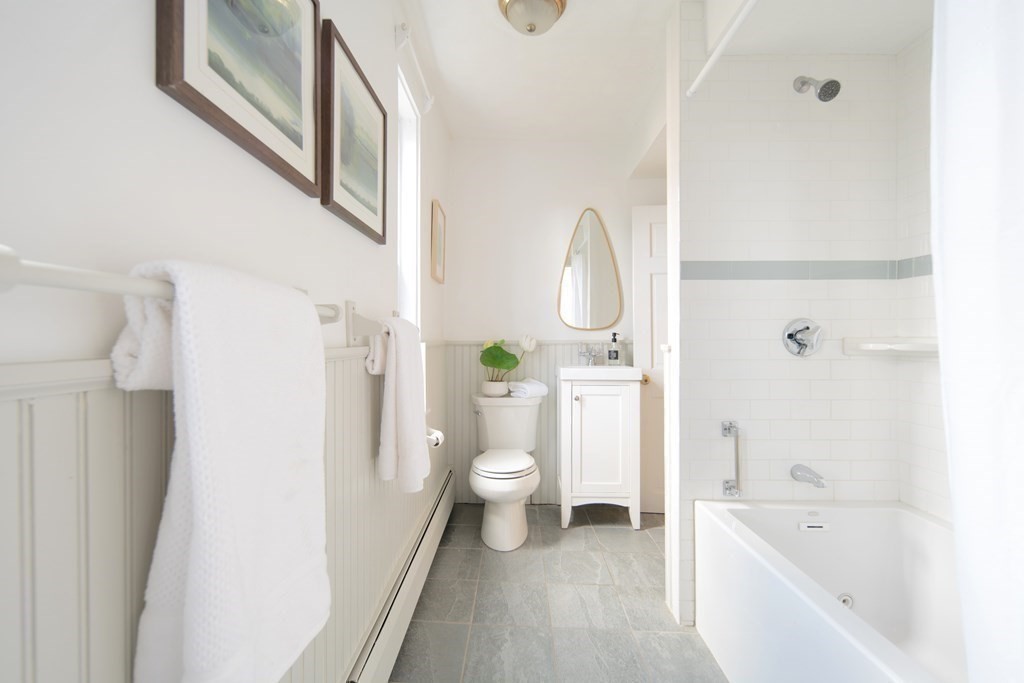 63 Reed Street, Unit 63 Cambridge, MA 02140 - Photo 9 of 16 a bathroom with a sink a toilet and a bathtub