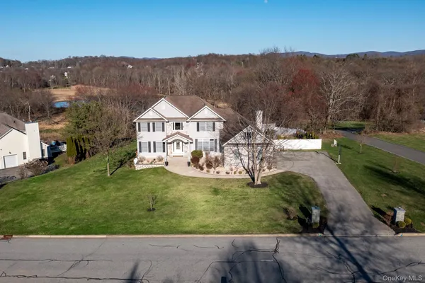 an aerial view of a house with garden space mountain view in back