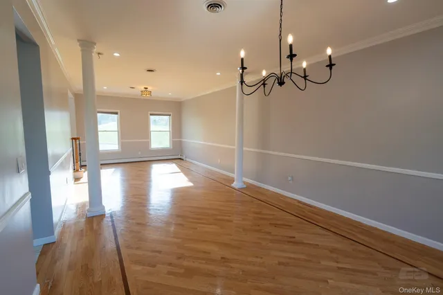 a view of a room with wooden floor and staircase