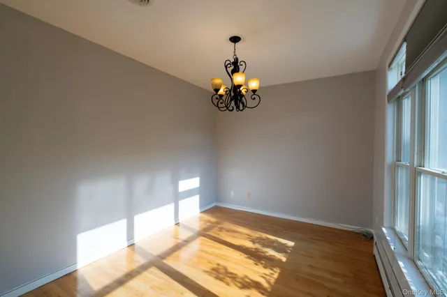 a view of a room with a window and wooden floor