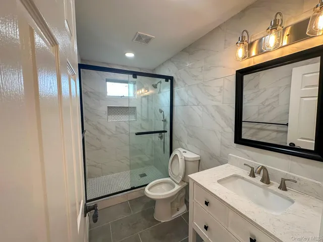 a bathroom with a toilet sink and shower