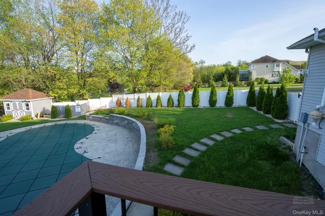 a view of a wooden deck and a yard