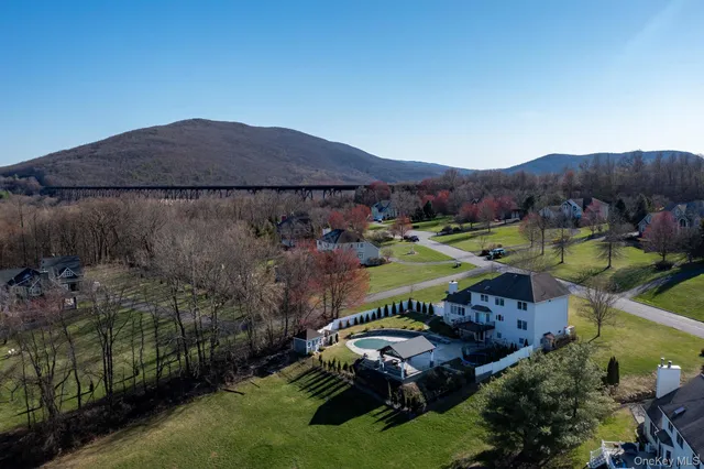 an aerial view of a house and mountain view