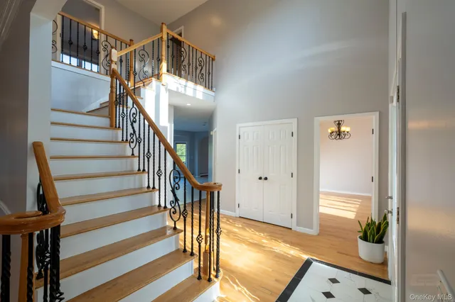 a view of entryway and hall with wooden floor