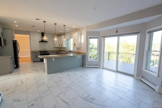 a large kitchen with cabinets and stainless steel appliances