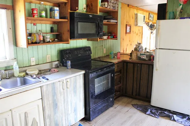 a kitchen with a sink and a stove top oven