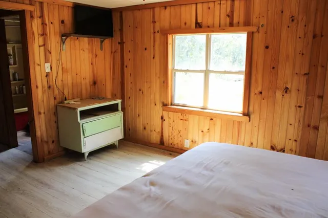 a view of a room with wooden floor and windows