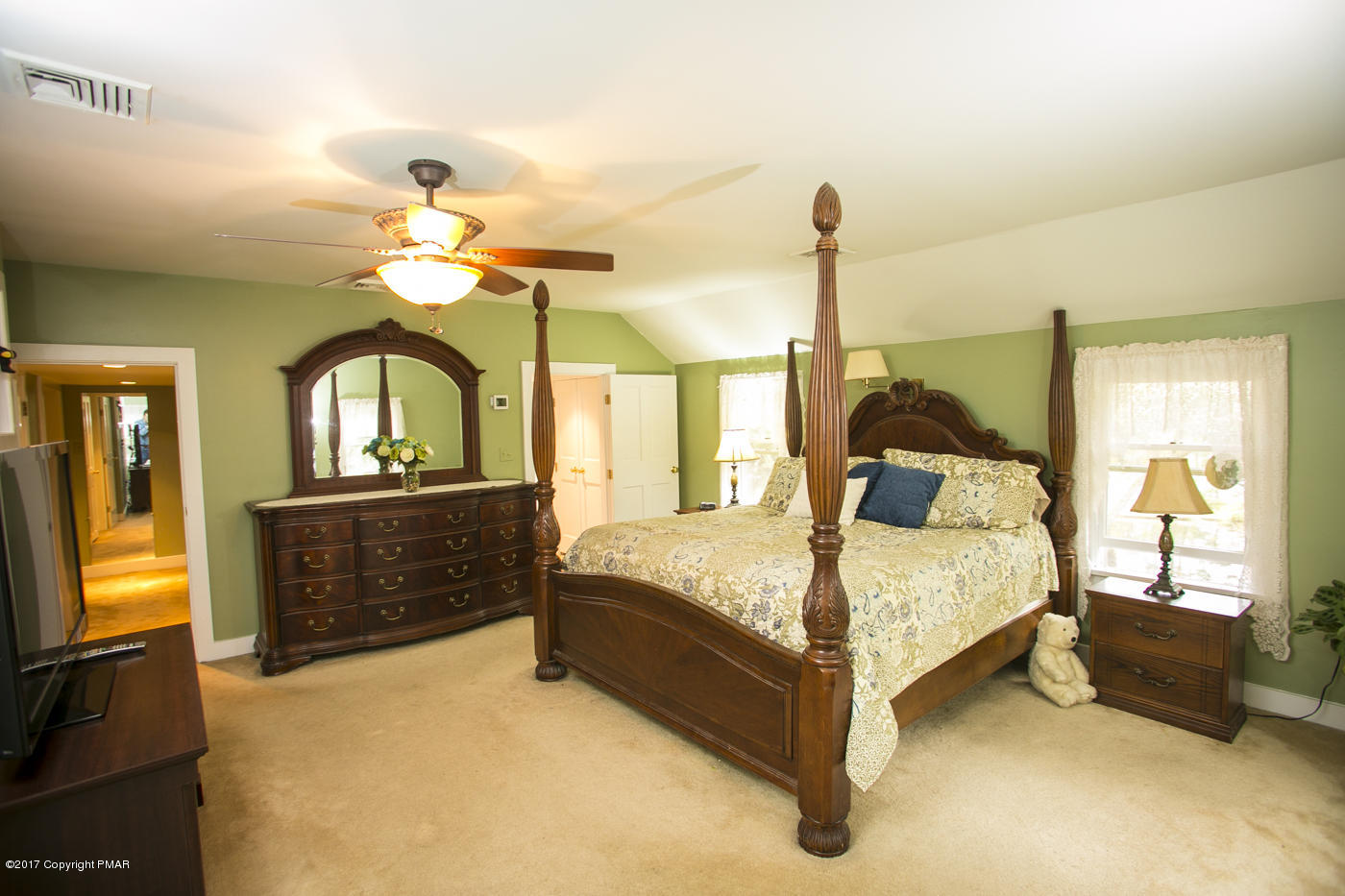 429 Upper Swiftwater Road Cresco, PA 18326 - Photo 18 of 50 a bed room with a bed and a chandelier