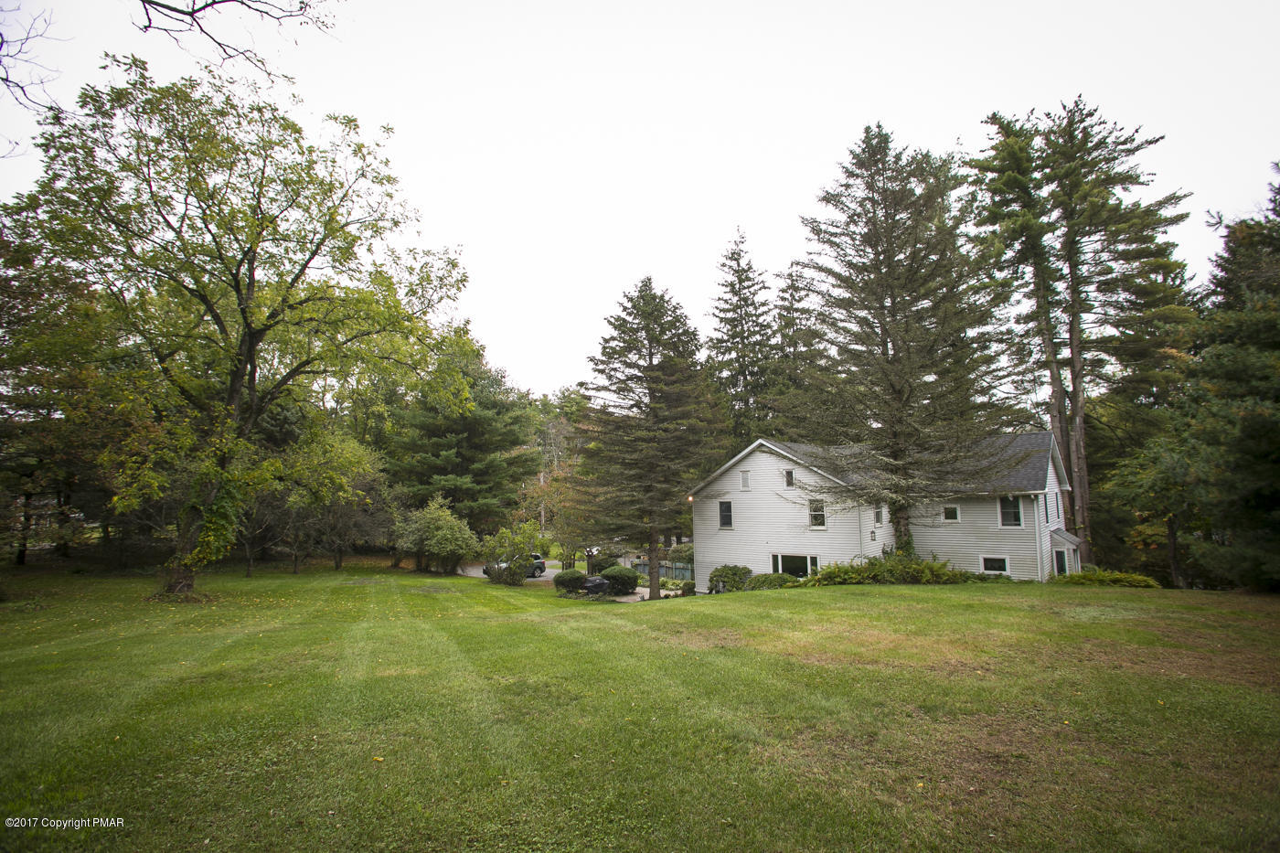 429 Upper Swiftwater Road Cresco, PA 18326 - Photo 42 of 50 a view of a white house in front of a big yard with large trees