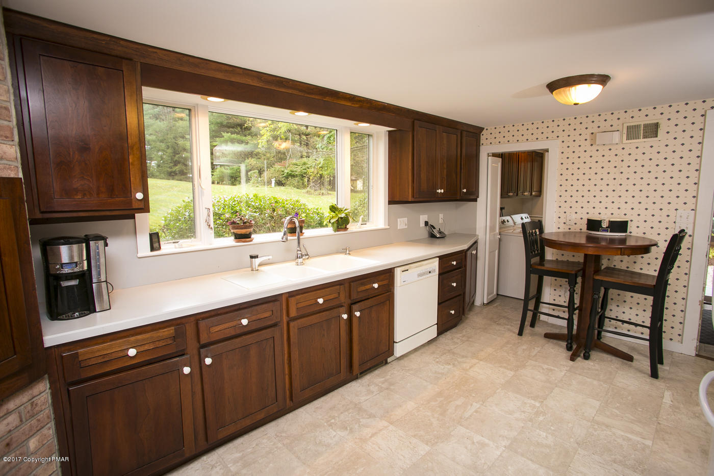 429 Upper Swiftwater Road Cresco, PA 18326 - Photo 10 of 50 a kitchen with stainless steel appliances granite countertop sink microwave and wooden cabinets