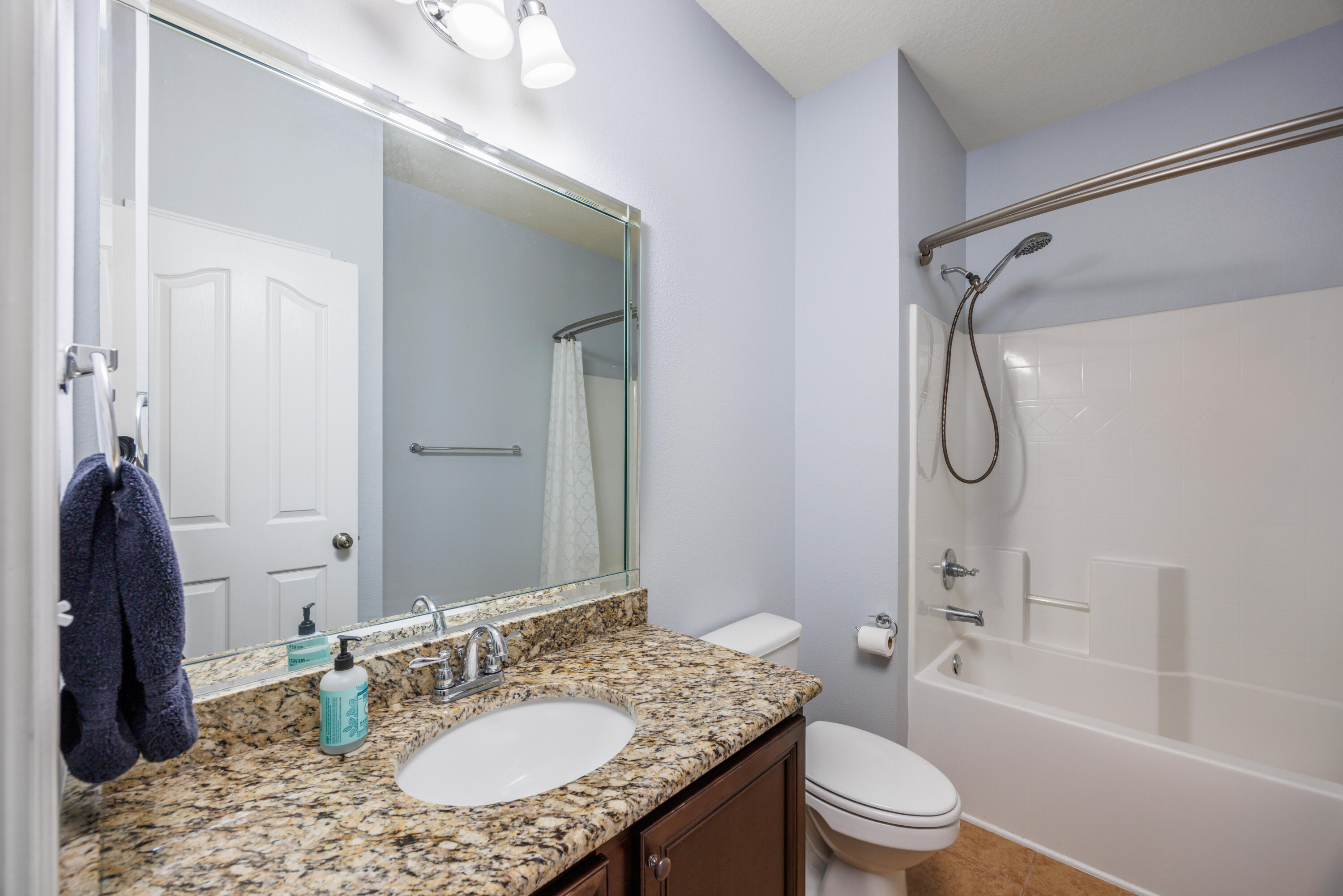 38 Camellia Court Freeport, FL 32439 - Photo 24 of 91 a bathroom with a granite countertop sink toilet mirror and shower