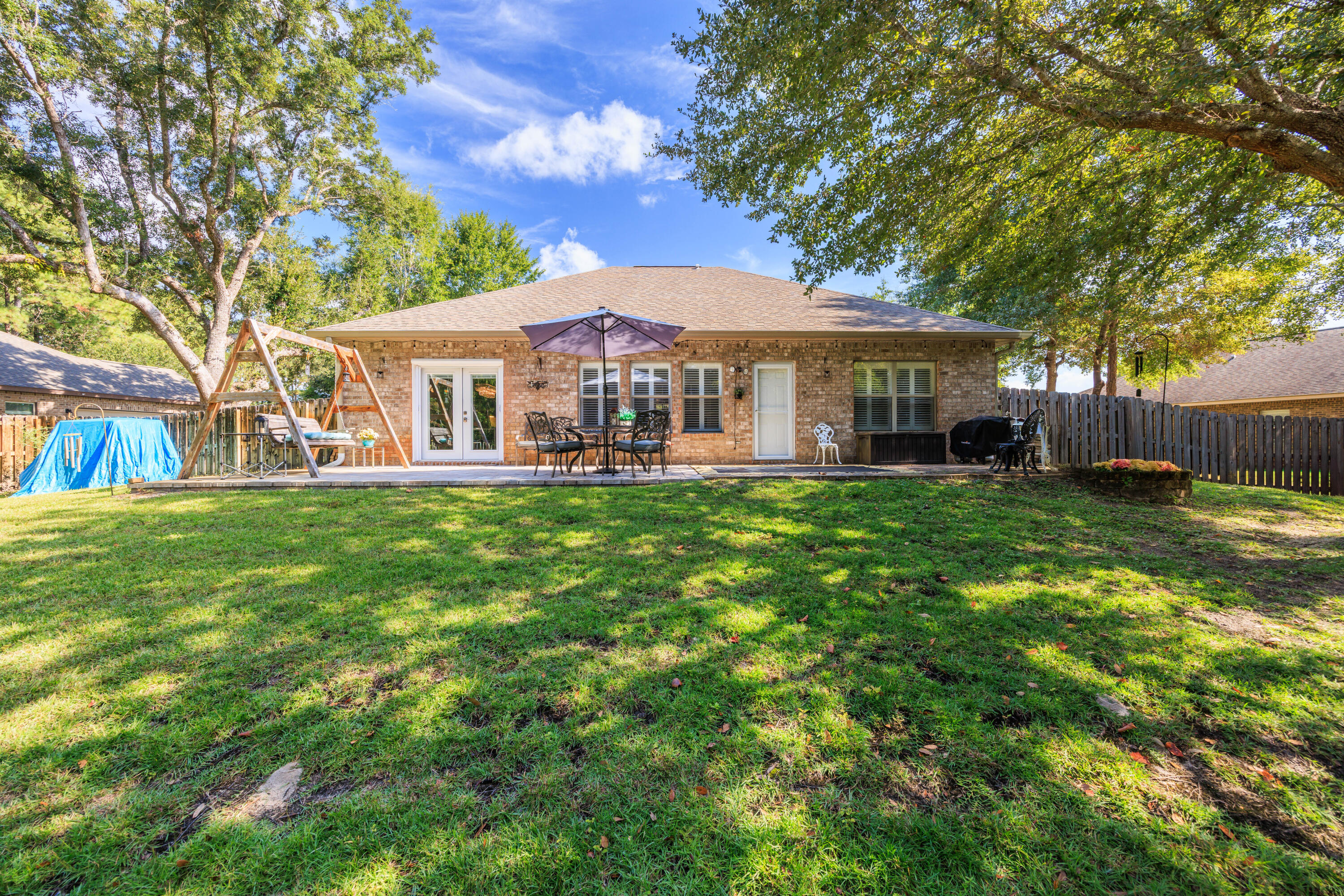 38 Camellia Court Freeport, FL 32439 - Photo 26 of 91 a front view of a house with a yard porch and sitting area
