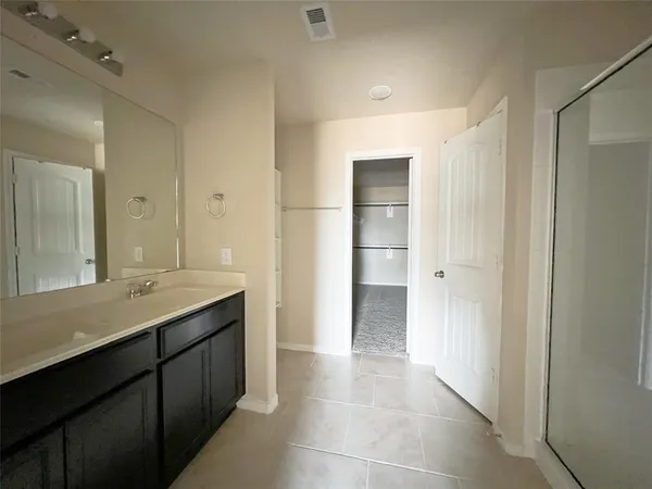 a bathroom with a granite countertop sink a toilet and a mirror