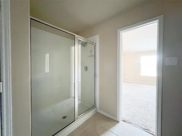 a view of a hallway with windows and stairs