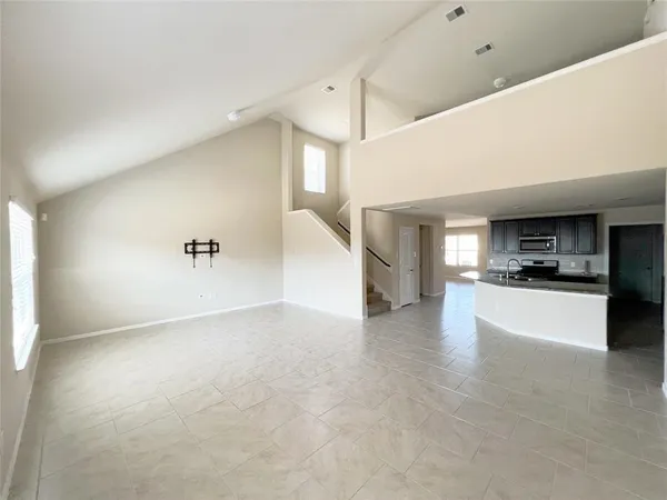 a view of open kitchen with a sink and cabinets