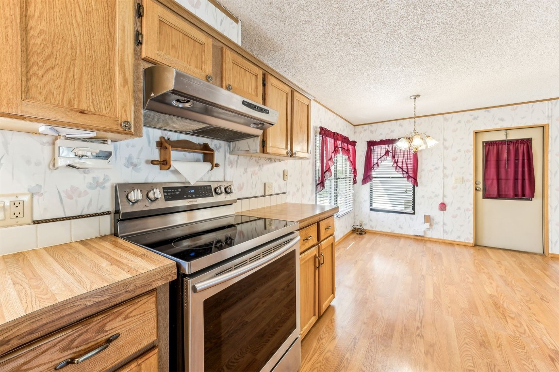 85256 Stephen Road Yulee, FL 32097 - Photo 11 of 40 a kitchen that has a stove and a wooden floor
