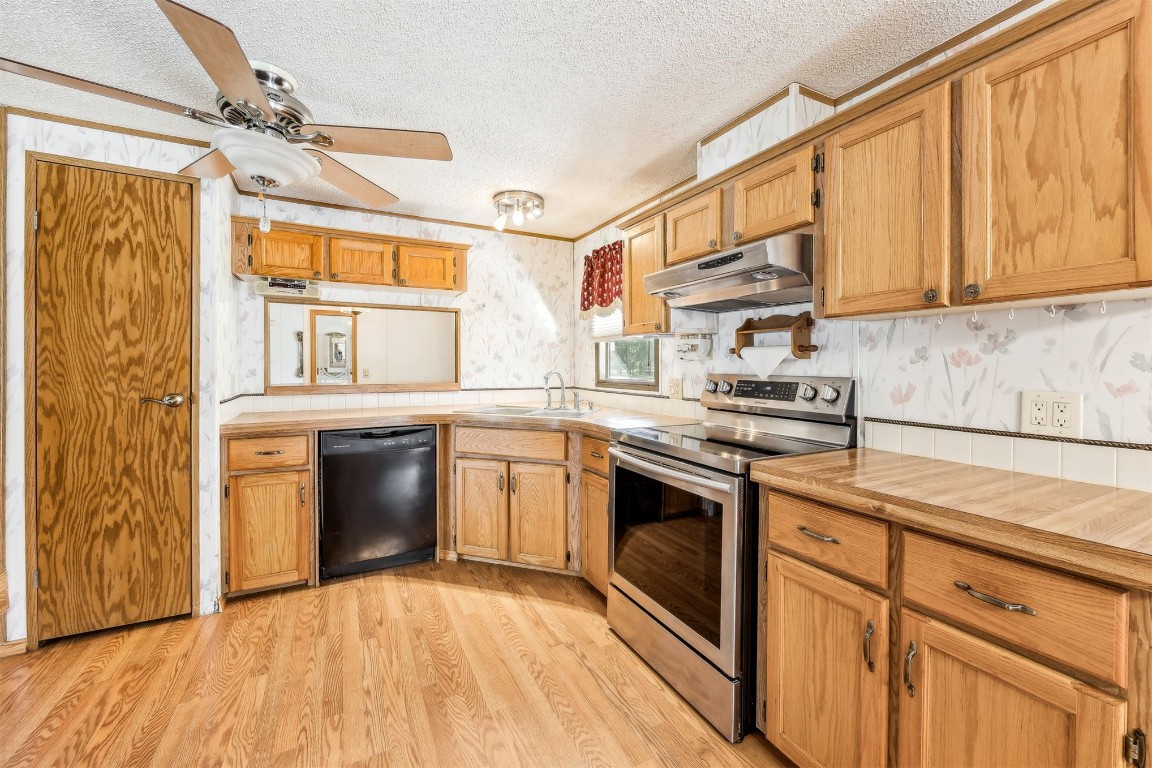 85256 Stephen Road Yulee, FL 32097 - Photo 12 of 40 a kitchen with stainless steel appliances granite countertop a sink a stove and a refrigerator