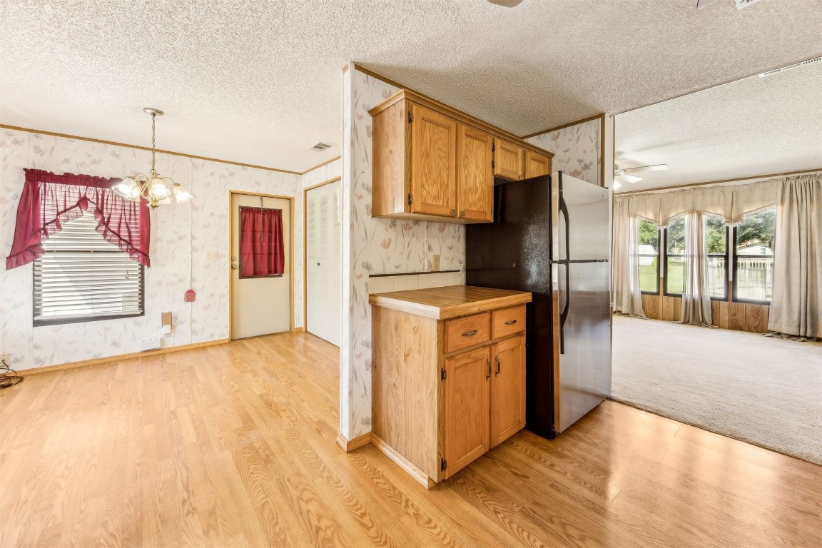 85256 Stephen Road Yulee, FL 32097 - Photo 15 of 40 a kitchen with stainless steel appliances granite countertop a refrigerator a oven a sink with wooden cabinets and wooden floor