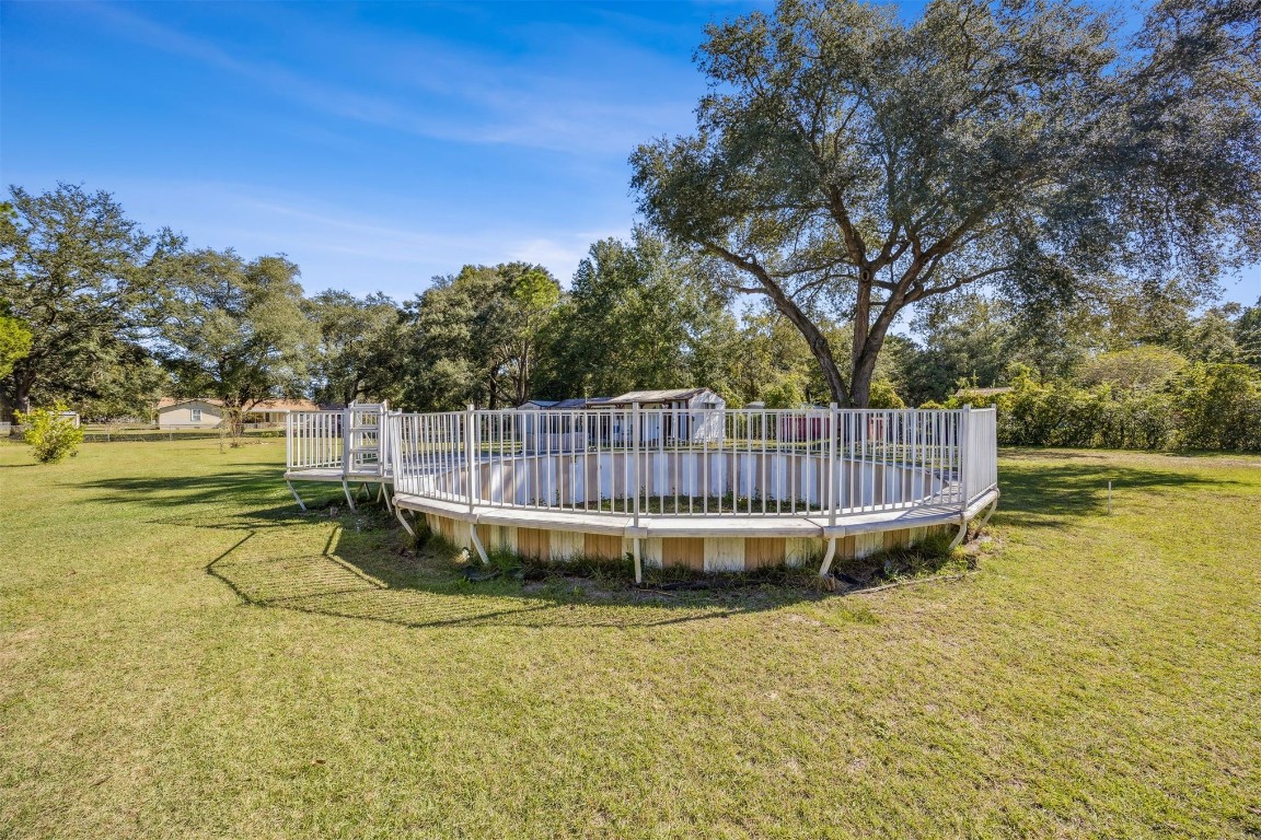 85256 Stephen Road Yulee, FL 32097 - Photo 29 of 40 a view of a swimming pool with a garden
