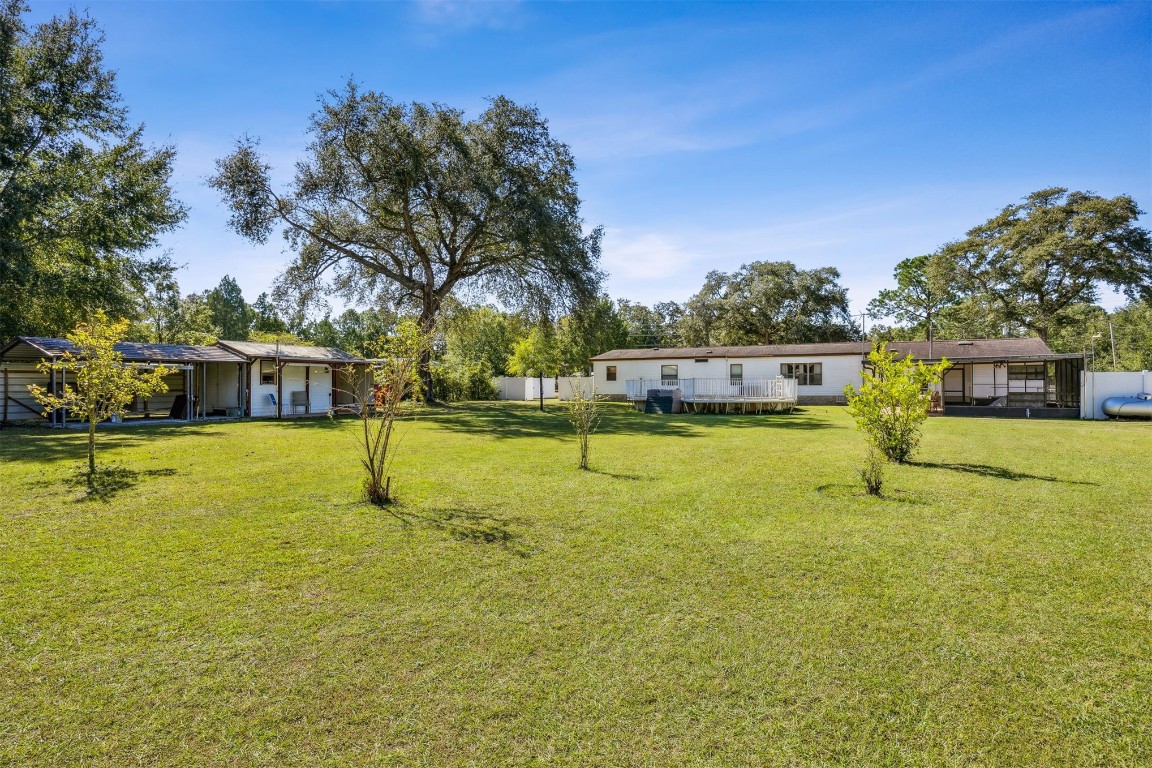 85256 Stephen Road Yulee, FL 32097 - Photo 37 of 40 a swimming pool with outdoor seating and yard