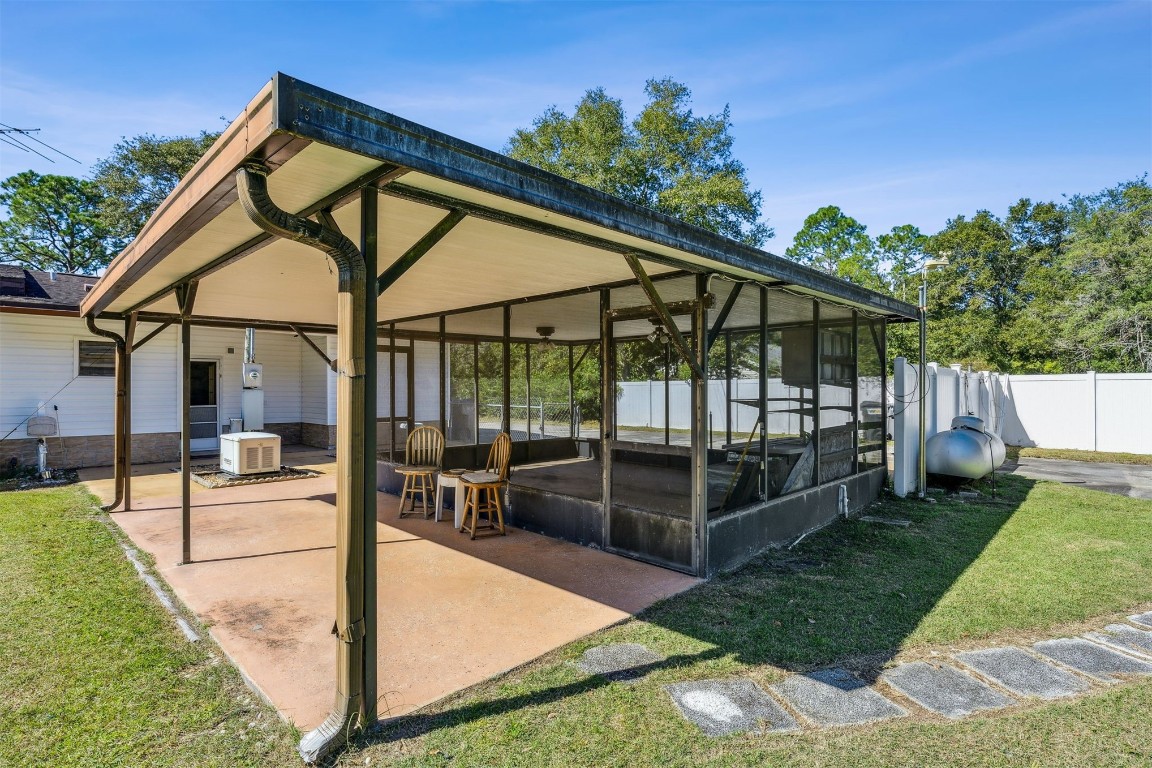 85256 Stephen Road Yulee, FL 32097 - Photo 39 of 40 a view of a house with a backyard and a patio