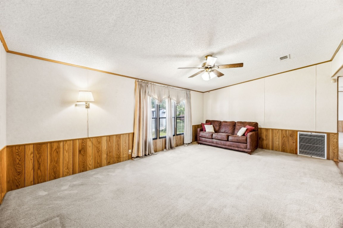 85256 Stephen Road Yulee, FL 32097 - Photo 10 of 40 a spacious bedroom with a bed and a chandelier