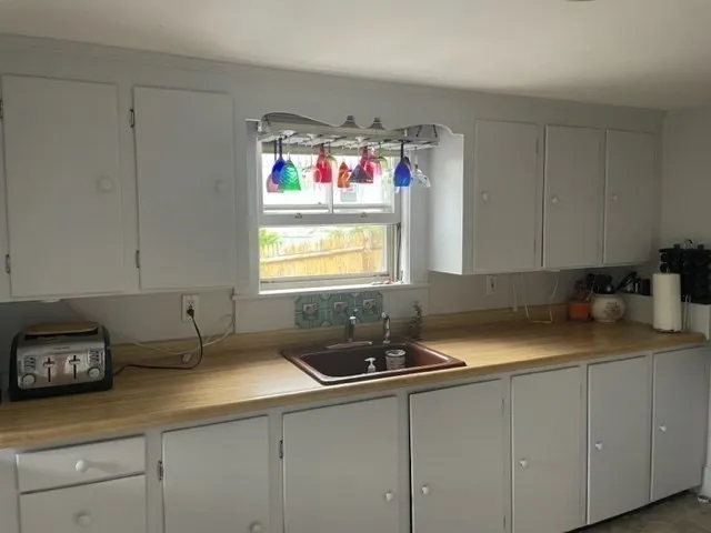 a white stove top oven sitting inside of a kitchen