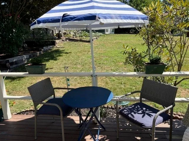 a view of a house with yard and sitting area
