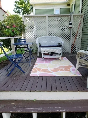 a wooden bench sitting at roof deck of house