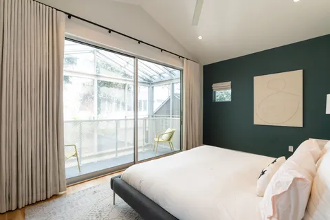 a bedroom with a large bed and a large window