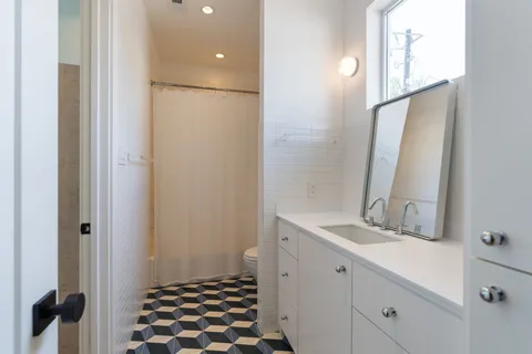 a living room with furniture and a dresser