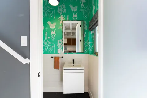 a view of a patio with couches chairs and floor to ceiling window with wooden fence