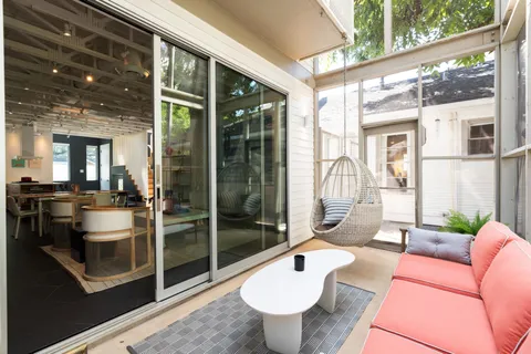 a view of a backyard with table and chairs and potted plants