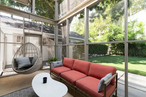 a front view of a house with a garden and plants