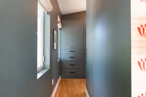 a room with a baby crib furniture and a window