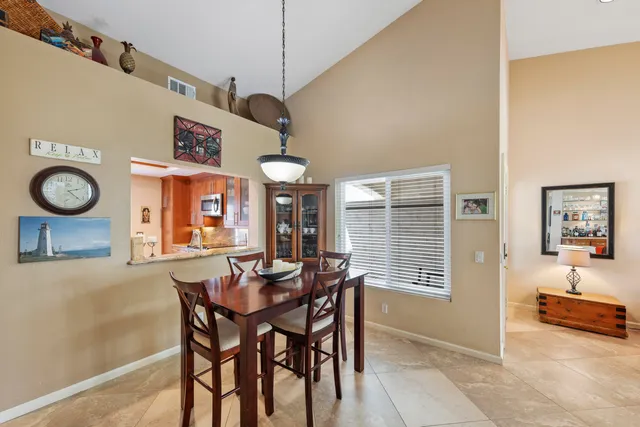 a view of a dining room with furniture and a large window