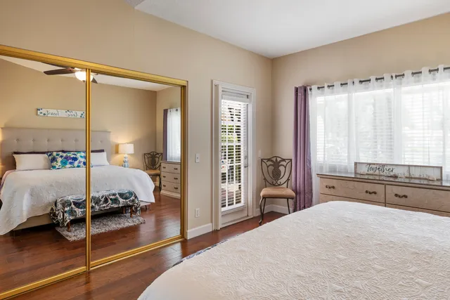 a spacious bedroom with a bed and a large window