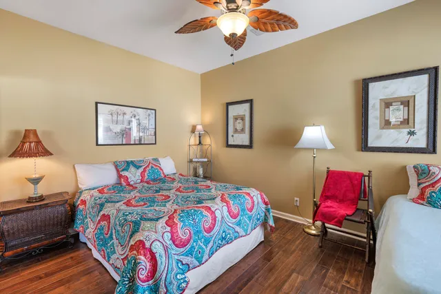 a bedroom with bed and a lamp on dresser