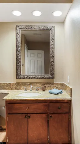 a bathroom with a sink vanity and a mirror