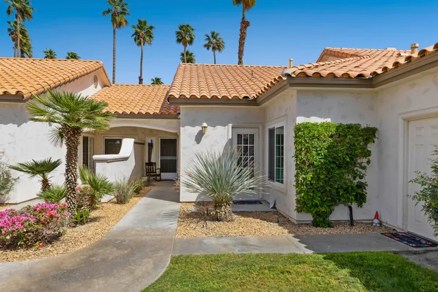 a view of a house with potted plants