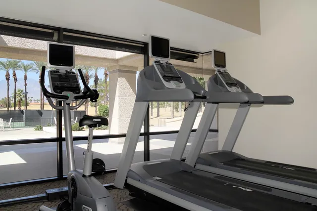 a room with gym equipment and mirrors