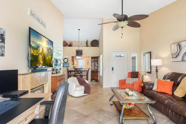 a living room with furniture a flat screen tv and a fireplace