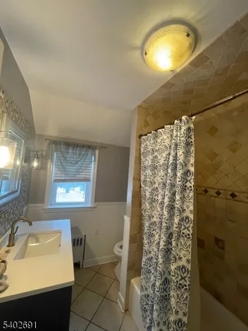 a view of a house with a backyard and a patio